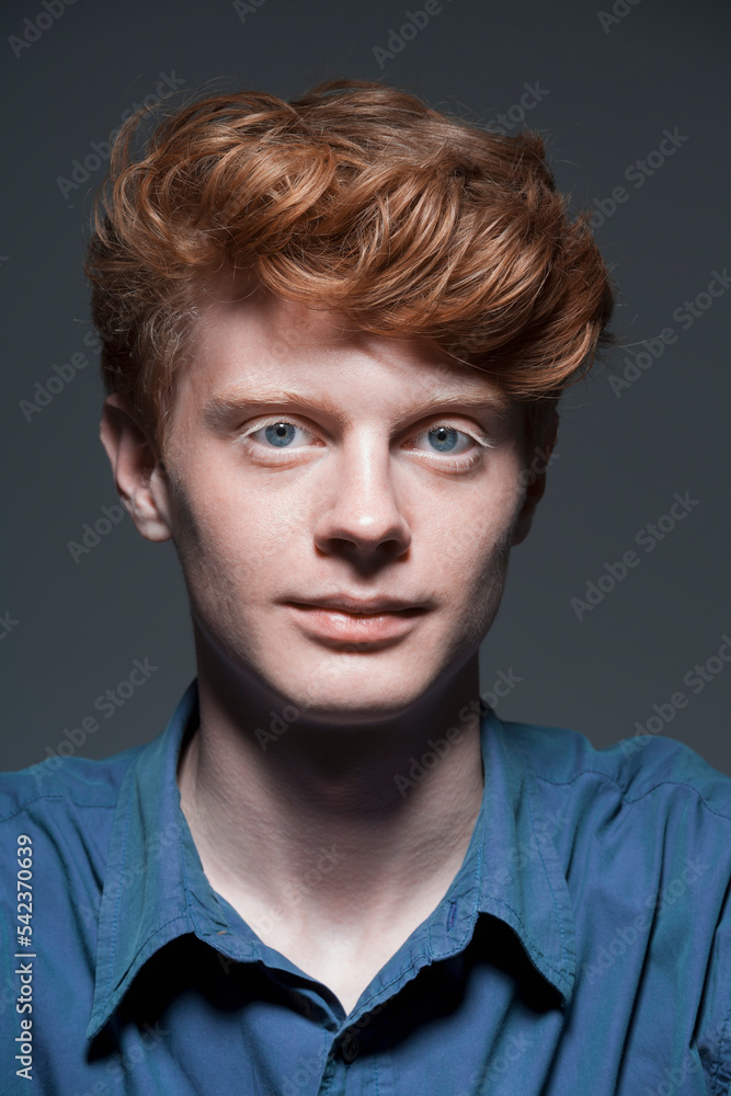 Portrait of young man against grey background, close up Portrait of young man against grey background, close up