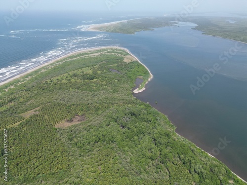 Gorgeous aerial view of the El Espino beach in El Salvador with lush green trees and calm waters