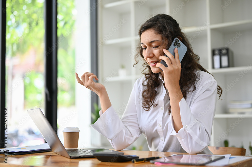 Professional caucasian businesswoman talking on the phone with someone Professional caucasian businesswoman talking on the phone with someone