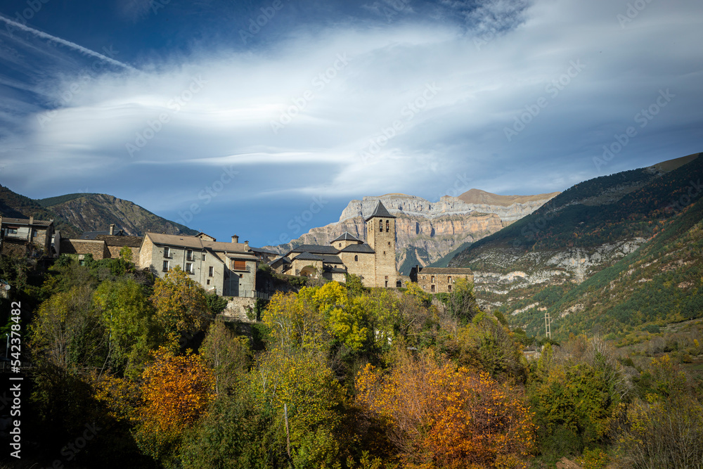 Obraz premium Scenic landscape with Orla Church in the center and mountains of Ordesa y Monte Perdido National Park, Spain, in the background