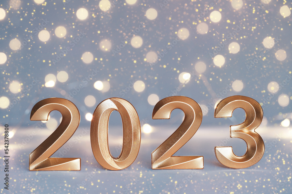 Golden numbers of year 2023. Glowing festive garland with bokeh on light background. Happy New Year greeting card. Greeting card with stars Golden numbers of year 2023. Glowing festive garland with bokeh on light background. Happy New Year greeting card. Greeting card with stars
