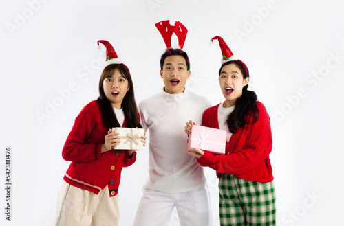 Group of young asian people in red and white sweatshirt to celebrate christmas party white background. 