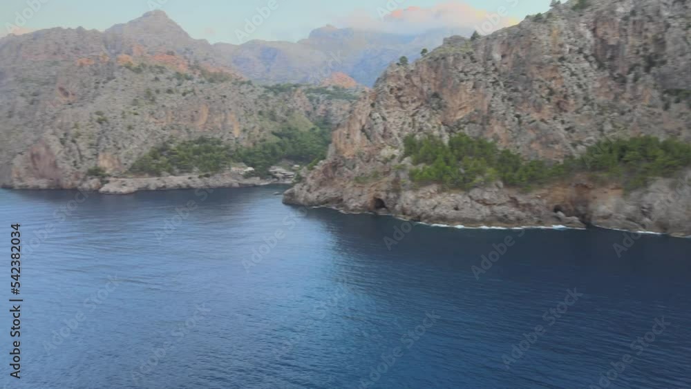 Rotating drone shot of Sa Calobra and Torrent de Pareis from afar above the Mediterranean sea in Mallorca, Spain. Rotating drone shot of Sa Calobra and Torrent de Pareis from afar above the Mediterranean sea in Mallorca, Spain.