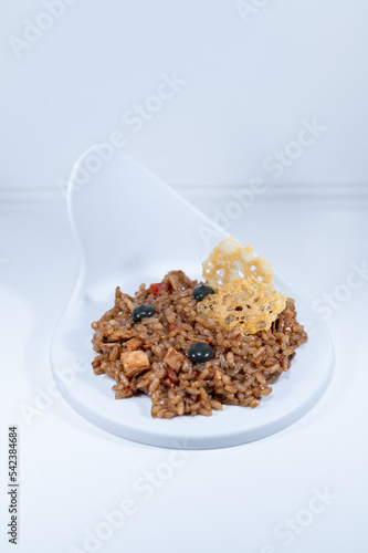 yellow paella risotto balck pearls parmessan cheese elegant dish photo