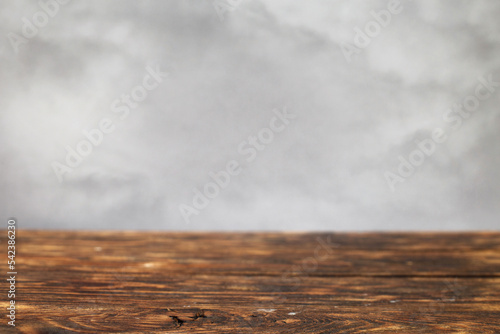 empty wooden brown table on a grey smoke background