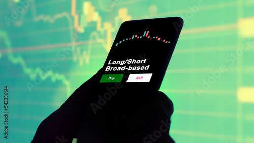 An investor's analyzing the Long/Short Broad-based etf fund on screen. A phone shows the ETF's prices real estate investment trust reit to invest