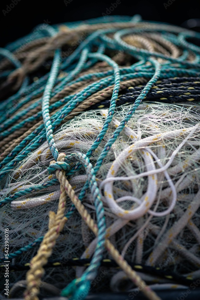 Vertical closeup shot of tangled ocean nets with details