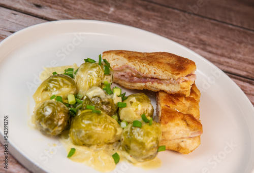 Recipe for homemade chicken fillet cordon bleu style with Brussels sprouts. High quality photo