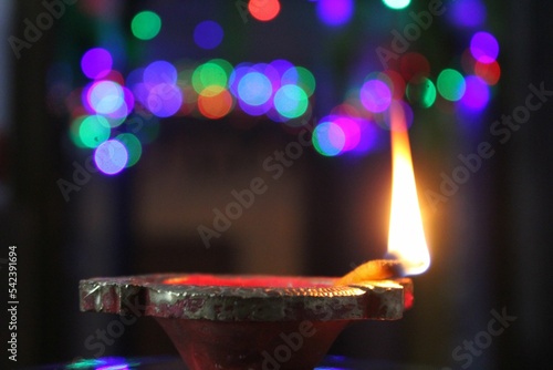 Closeup of a lit diya lamp at home at night for Diwali