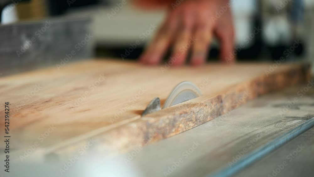 Close up wood worker cutting wood planks with saw machine. carpenter. Close up wood worker cutting wood planks with saw machine. carpenter.