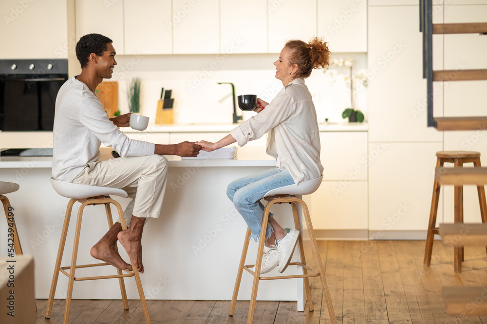 Couple spending time together and having breakfast in the kitchen