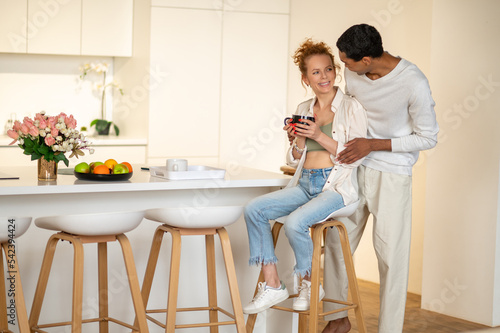 Couple spending time together and having breakfast in the kitchen