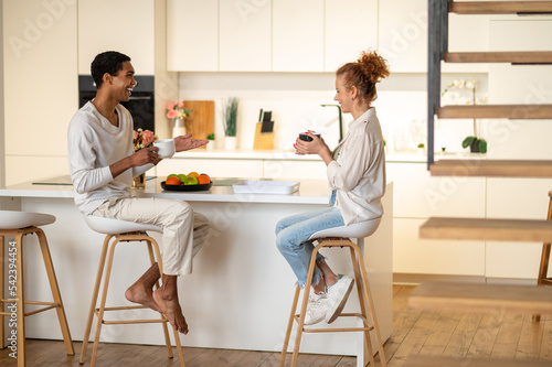 Couple spending time together and having breakfast in the kitchen