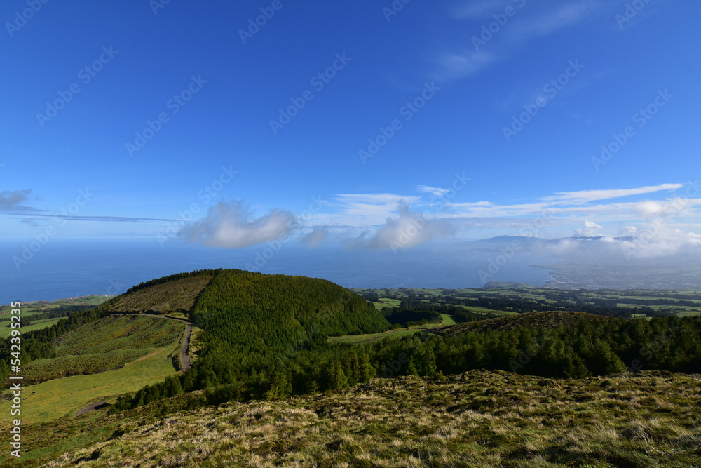 Fototapeta premium Clouds Floating Over Lush Landscape in the Azores