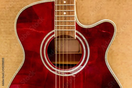 Acoustic guitar in red close-up. Close-up of the guitar