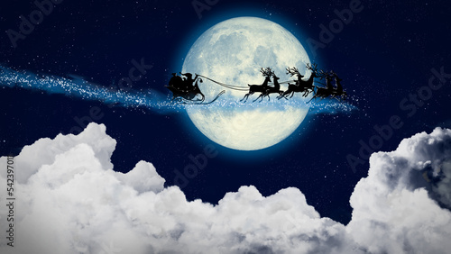 Fotografia Santa Claus in a sleigh flying over the moon at night