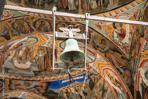 Old church bell in background frescoes from Orthodox church closeup