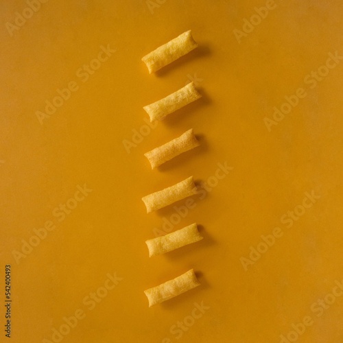 Row of crunchy cookies on a yellow background