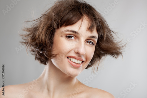 beauty portrait of a brunette girl with short hair in the air
