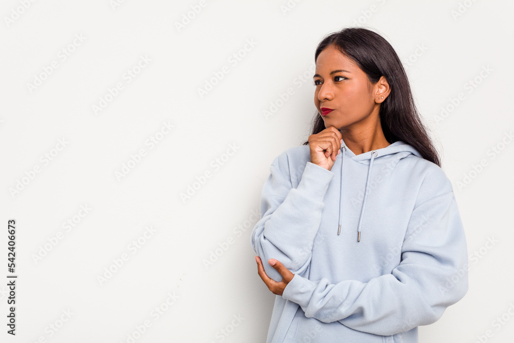Young Indian woman isolated on white background looking sideways with doubtful and skeptical expression. Young Indian woman isolated on white background looking sideways with doubtful and skeptical expression.