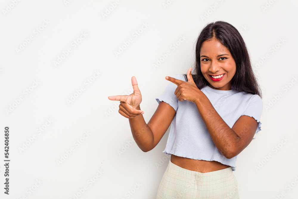 Young Indian woman isolated on white background excited pointing with forefingers away. Young Indian woman isolated on white background excited pointing with forefingers away.