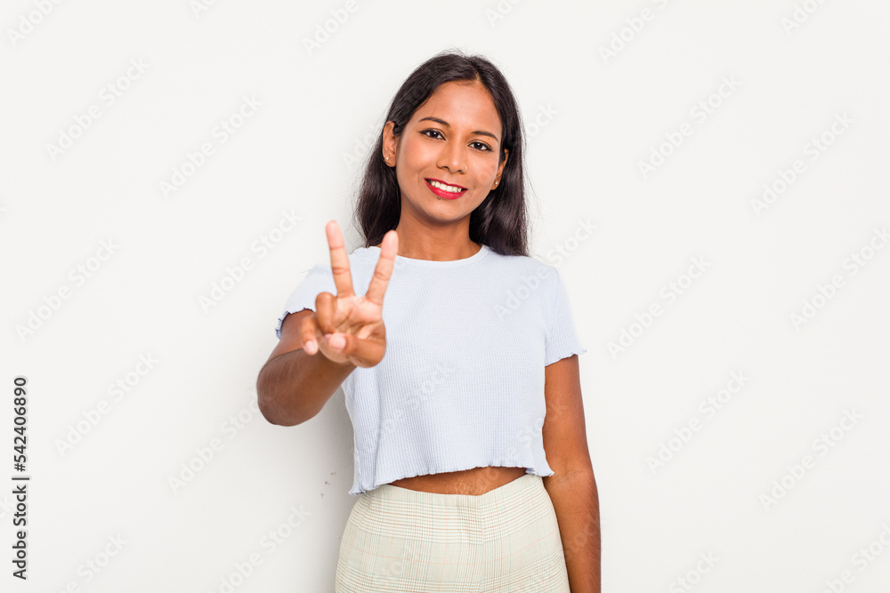 Young Indian woman isolated on white background showing victory sign and smiling broadly. Young Indian woman isolated on white background showing victory sign and smiling broadly.