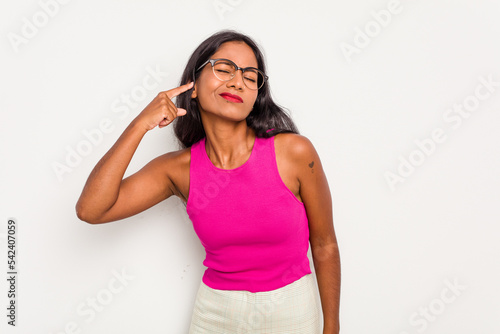 Young Indian woman isolated on white background covering ears with fingers, stressed and desperate by a loudly ambient. © Asier