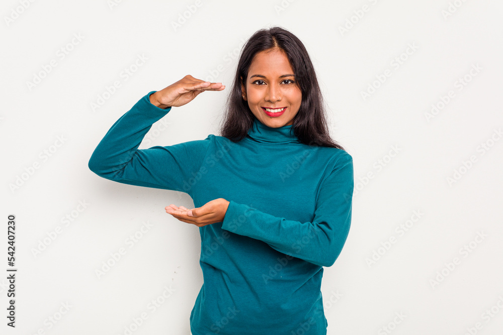 Young Indian woman isolated on white background holding something little with forefingers, smiling and confident. Young Indian woman isolated on white background holding something little with forefingers, smiling and confident.