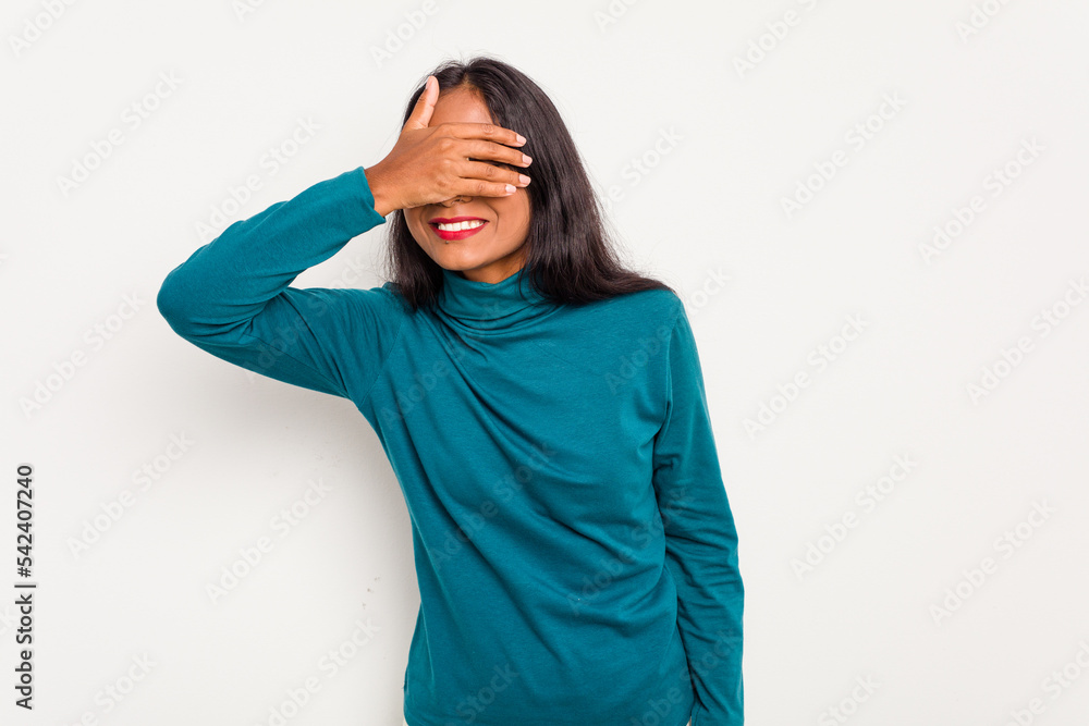Young Indian woman isolated on white background covers eyes with hands, smiles broadly waiting for a surprise. Young Indian woman isolated on white background covers eyes with hands, smiles broadly waiting for a surprise.