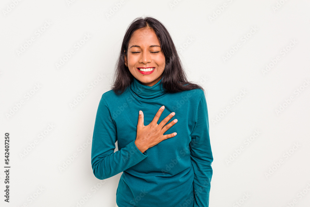 Young Indian woman isolated on white background laughs out loudly keeping hand on chest. Young Indian woman isolated on white background laughs out loudly keeping hand on chest.