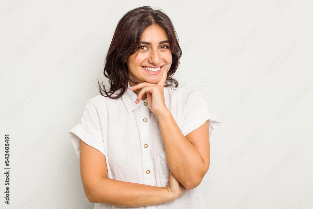 Young Indian woman isolated on white background smiling happy and confident, touching chin with hand. Young Indian woman isolated on white background smiling happy and confident, touching chin with hand.