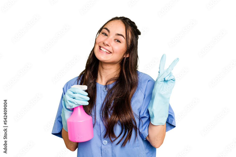 Young cleaner caucasian woman isolated on green chroma background joyful and carefree showing a peace symbol with fingers. Young cleaner caucasian woman isolated on green chroma background joyful and carefree showing a peace symbol with fingers.