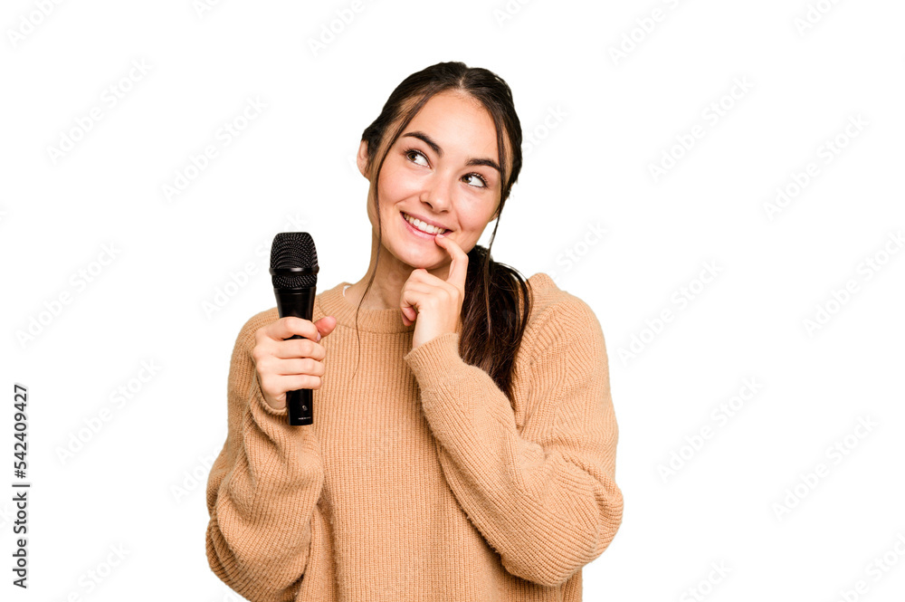 Young caucasian singer woman isolated on green chroma background relaxed thinking about something looking at a copy space. Young caucasian singer woman isolated on green chroma background relaxed thinking about something looking at a copy space.