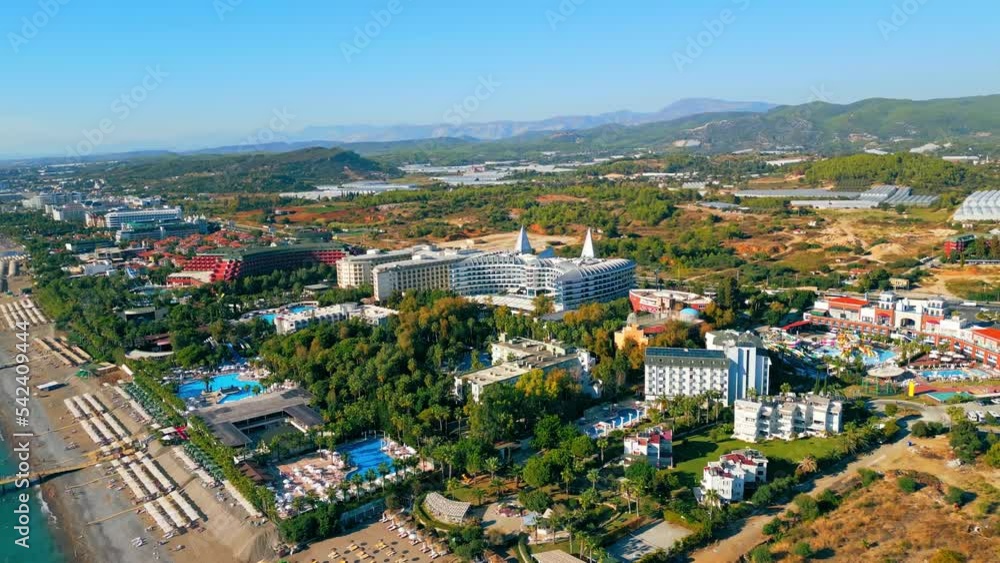 ascending view of hotels, pools and beaches surrounded with palm trees, the best place for summer holidays, Okurcalar, Turkey. High quality 4k footage ascending view of hotels, pools and beaches surrounded with palm trees, the best place for summer holidays, Okurcalar, Turkey. High quality 4k footage