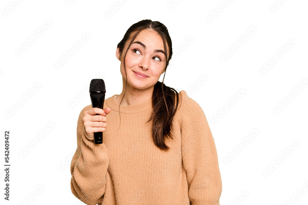 Young caucasian singer woman isolated on green chroma background dreaming of achieving goals and purposes Young caucasian singer woman isolated on green chroma background dreaming of achieving goals and purposes