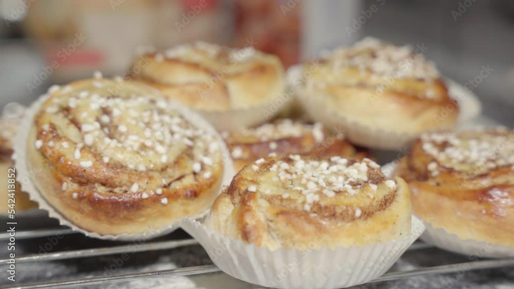 Male hand picking up a cinnamon bun. Male hand picking up a cinnamon bun.