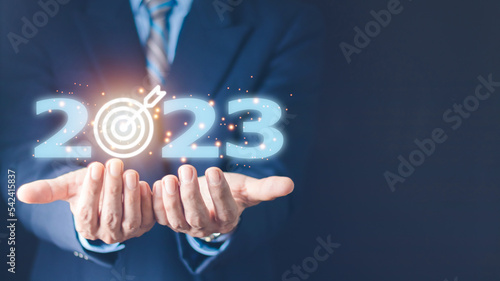 business target and goal on New year 2023 concept, hand holding 2023 virtual screen. new years business. new ideas coming up in the future.