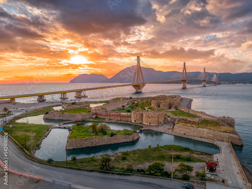Aerial view of Rio (Rion) fortress near Patras and the Rion-Antirion bridge Greece protecting and crossing the entrance to the Gulf of Corinth with magical colorful sunset photo