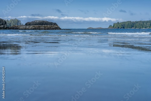 Beautiful shot of natural scenery with blue water on MacKenzie Beach in Tofino, Canada
