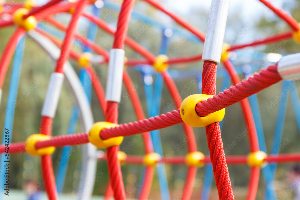 Red rope as mesh for climbing on playground