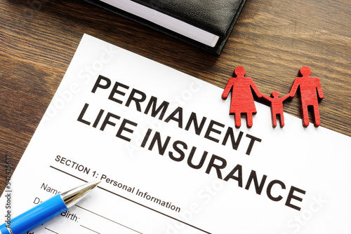 Permanent life insurance application and family figurine.