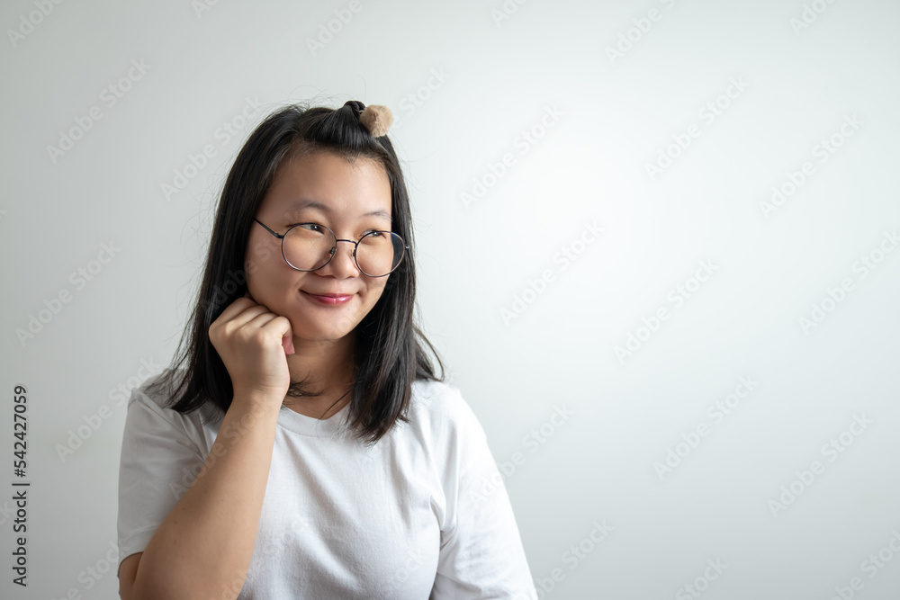 Asian Glassese Woman is touching her cheek and thinking somethings on white background in studio light.