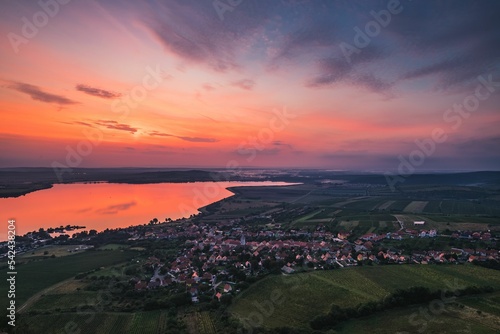 Mesmerizing shot of a seascape near a town under the clouds during the sunset © Roman Ivicic/Wirestock Creators