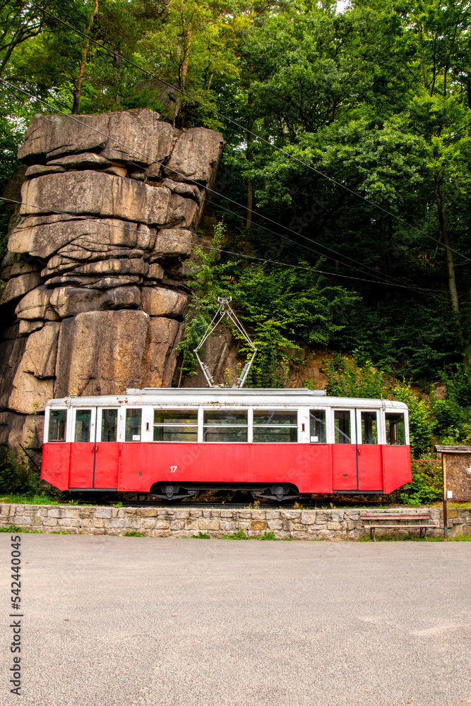 A white and red streetcar under a rock. Podgórzyn, Karkonosze