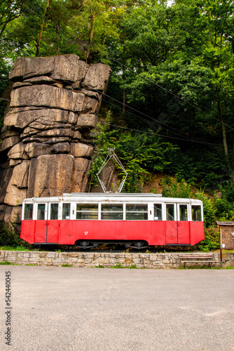 Obraz na płótnie A white and red streetcar under a rock. Podgórzyn, Karkonosze w salonie
