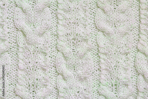 Light knitted wool texture. knitted braid pattern. Textured background