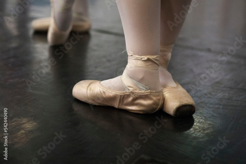 Feet of a ballerina with slippers during a rehearsal