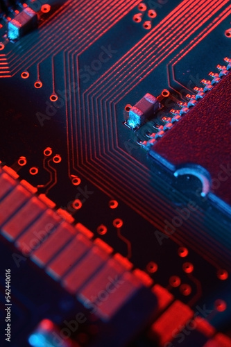 Computer cpu processor chip on circuit board ,motherboard background. Close-up. With red-blue lighting