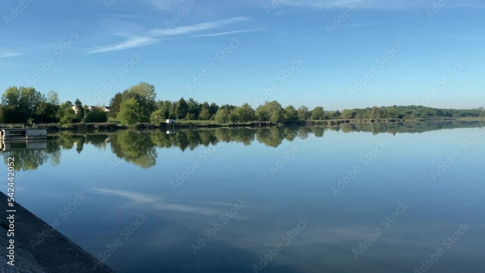 Man made lake in France with trees around the shore. Man made lake in France with trees around the shore.