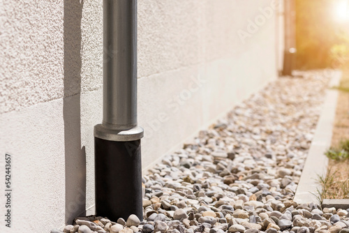 Εκτύπωση καμβά Storm Drainage Drain Downspout Pipe  Installing into French drain with  Drainage Stones Outside Building